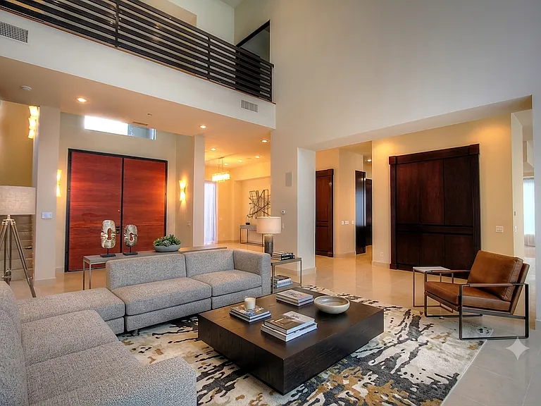 Spacious great room with soaring ceilings, abundant natural light, and seamless flow to the formal living areas.
