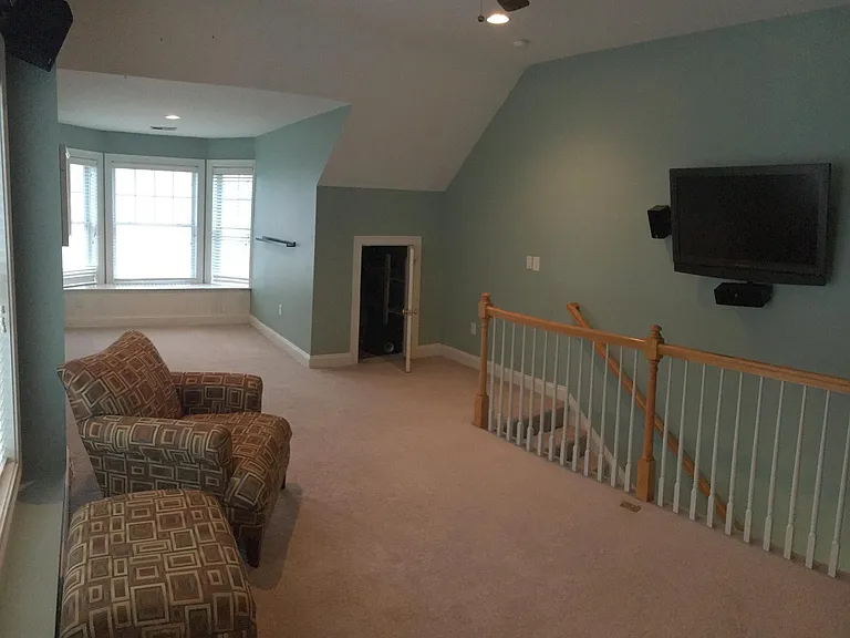 Third floor loft has wall mounted TV and all wiring with surround sound entertainment system. Large extra storage closet with shelving.