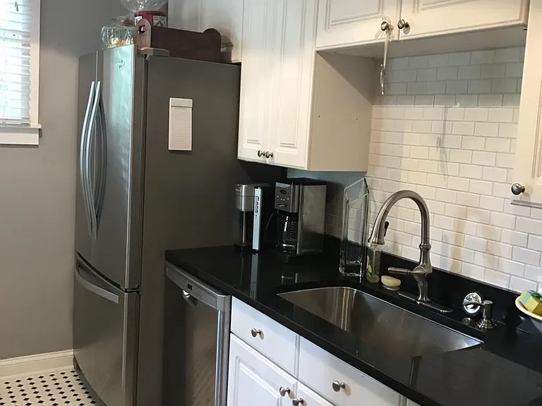 New sink and hardware and new dishwasher and large refrigerator