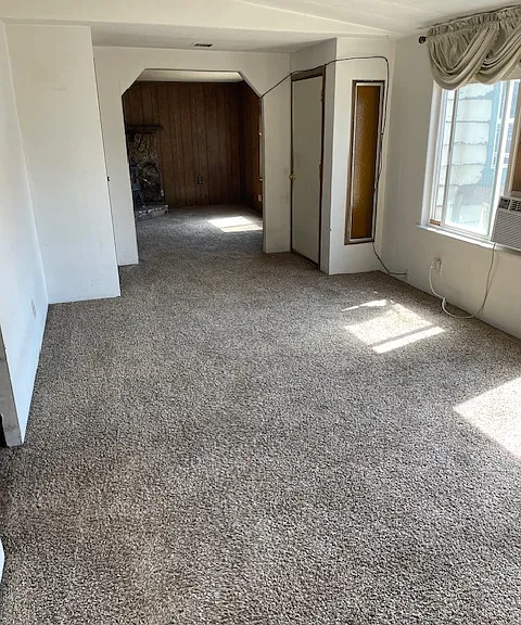 Formal Living area just inside the front door. Large space with lots of natural light. Currently, this room is furnished.