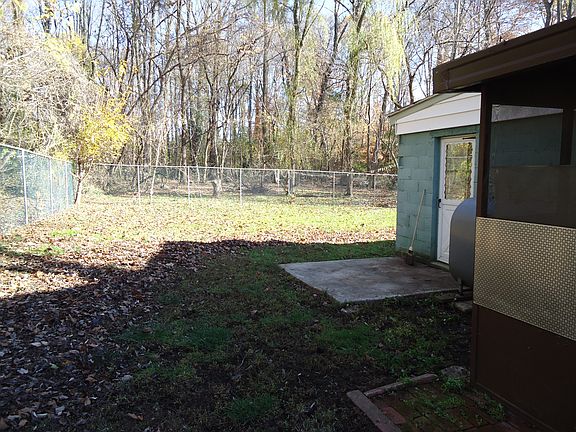 Fenced in yard from back porch showing mud room also
