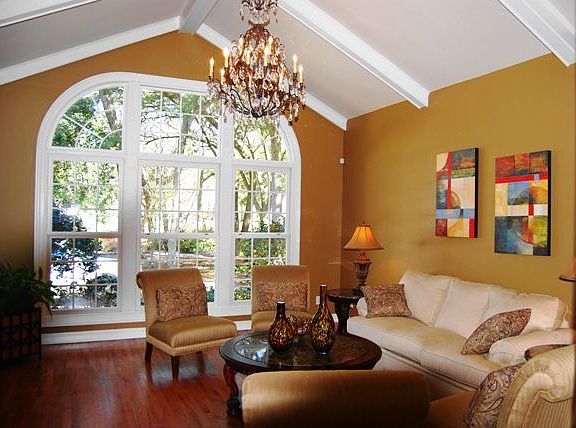 Living room features a vaulted ceiling and lots of light.