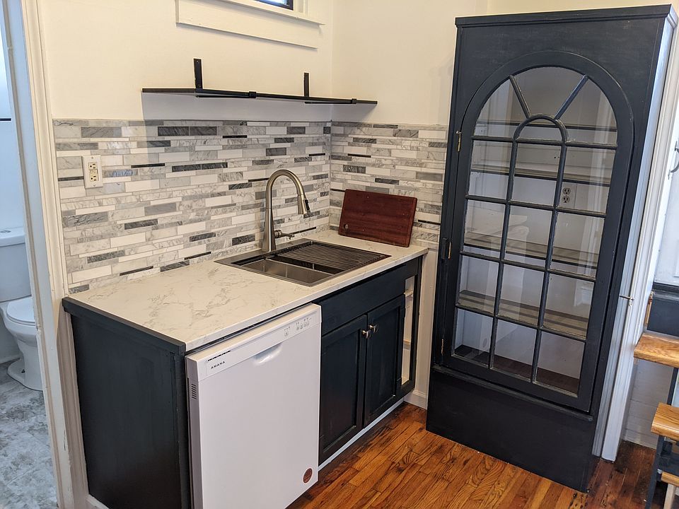Another view of the newly remodeled kitchen. Kitchen has gas range, new fixtures, new fridge, new dishwasher, new countertop, new sink. Roof deck access, Lots of cabinet, pantry, and shelf space. Marbled backsplashes at sink and range.