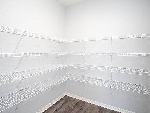 Convenient walk-in pantry - New home for sale in Lake Alfred, FL. Photo showcases a home with simila