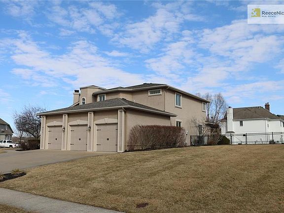 Three car garage stucco home with black aluminum fence so you won't miss any views of the community pond and come stay awhile and enjoy the view of the lake.