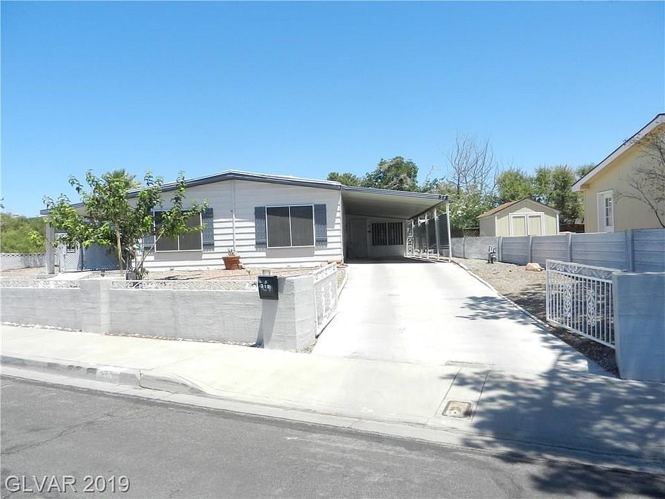 ENTRANCE TO COVERED CARPORT AND PARKING