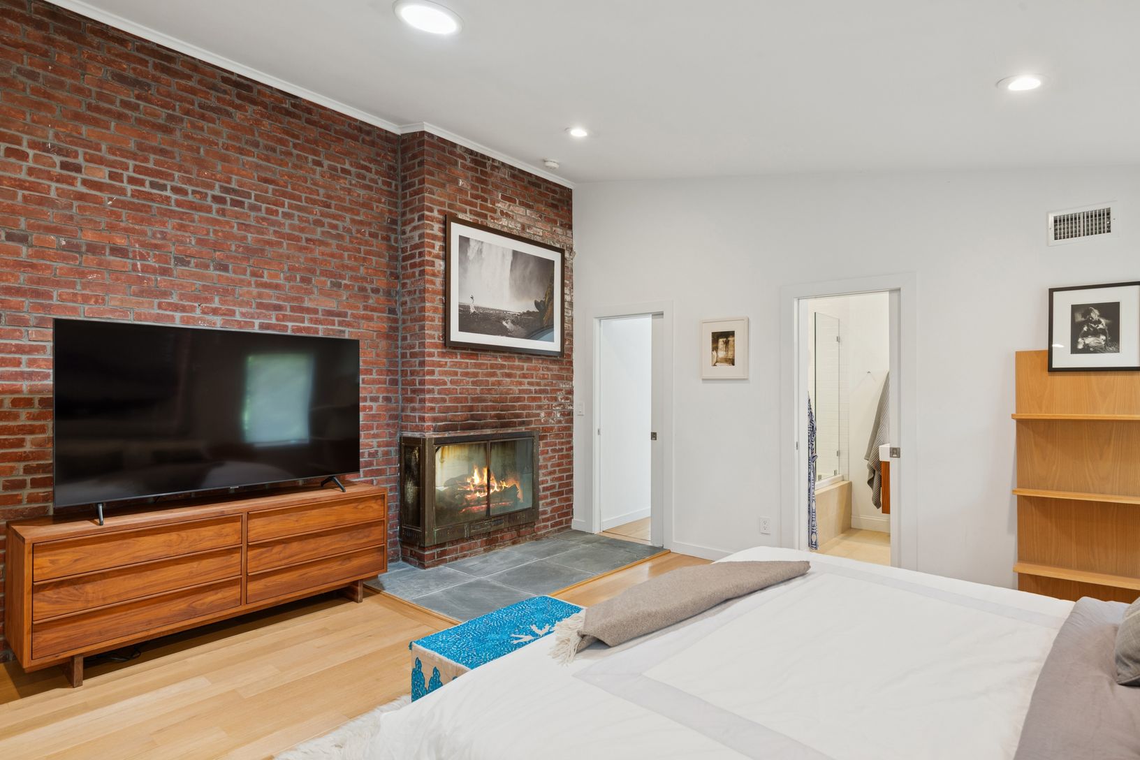  first floor primary with double-sided fireplace