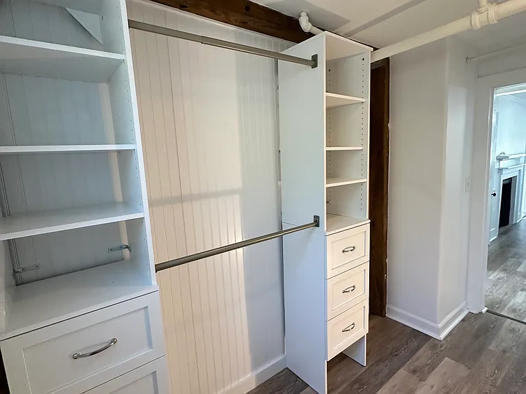 Small home office with storage unit that can also be used as a large walk in closet.