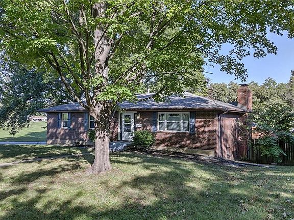 Raised ranch sits on a corner lot.