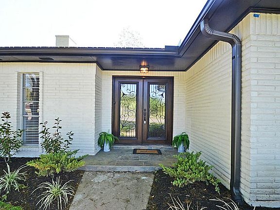 Beautiful landscape greets your guests. The front porch is tiled with slate. NEW double entry doors are sure to impress!