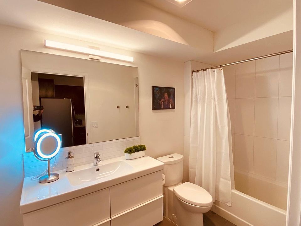 Large, clean, modern bathroom with bathtub.