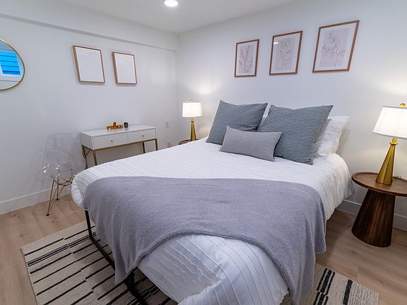 Comfortable queen sized bed with work desk space.
