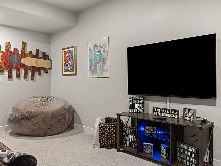 Lower level Living Room (furniture pictured is for staging purposes only - unfurnished unit)