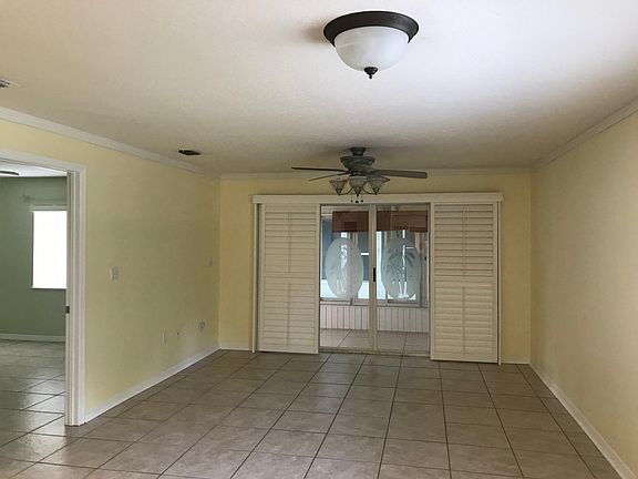 View from kitchen, master bedroom on the left, glass sliding doors seperate the living room and back porch area. All windows and glass sliding door have white plantation shutters