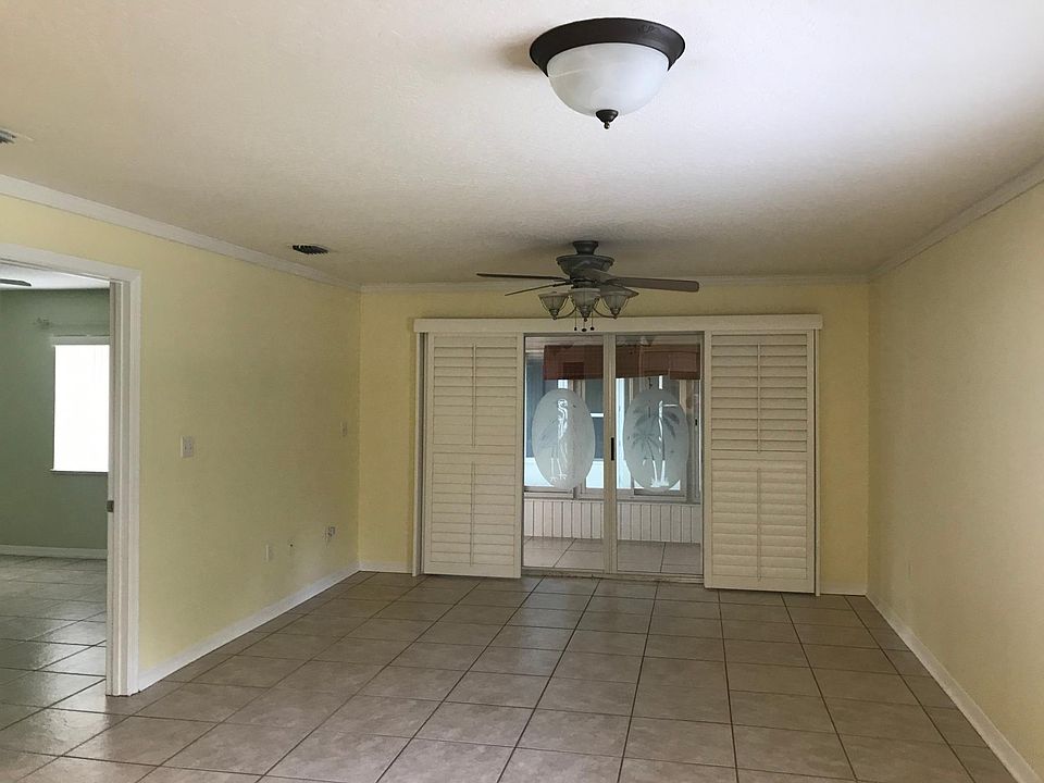 View from kitchen, master bedroom on the left, glass sliding doors seperate the living room and back porch area. All windows and glass sliding door have white plantation shutters