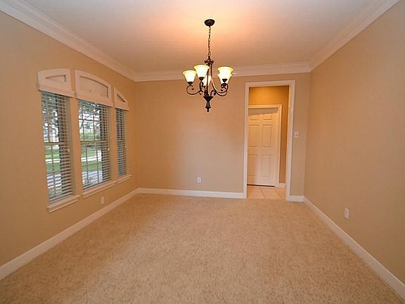 Dining room enhanced by double crown molding and access to the kitchen and new updated lighting.