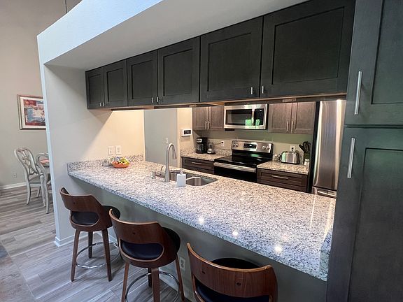 Remodeled immaculate kitchen with plentiful bar seating & cabinetry