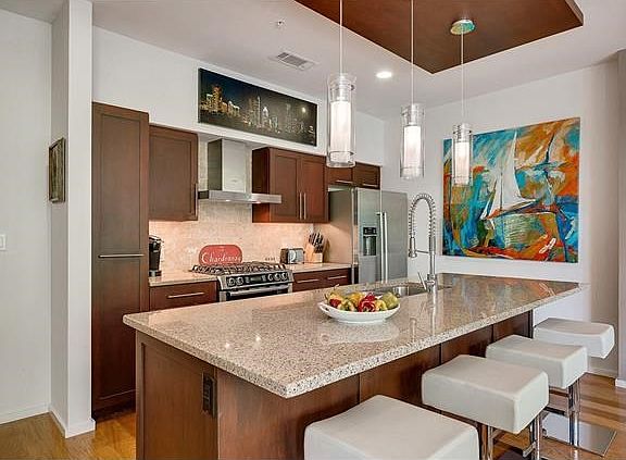 Modern kitchen with high-end stainless appliances including Bosch gas stove.