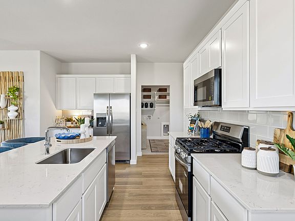 Kitchen in the Magnolia home plan by Trophy Signature Homes - REPRESENTATIVE PHOTO