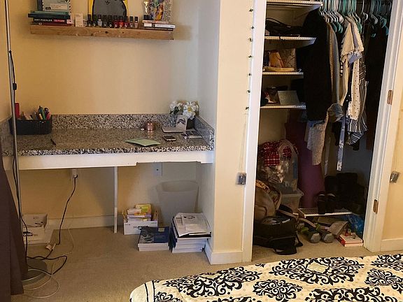 Den with built in desk, frosted sliding glass doors and attached 1/2 bath