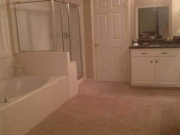 maaster bathroom with his/her, granite