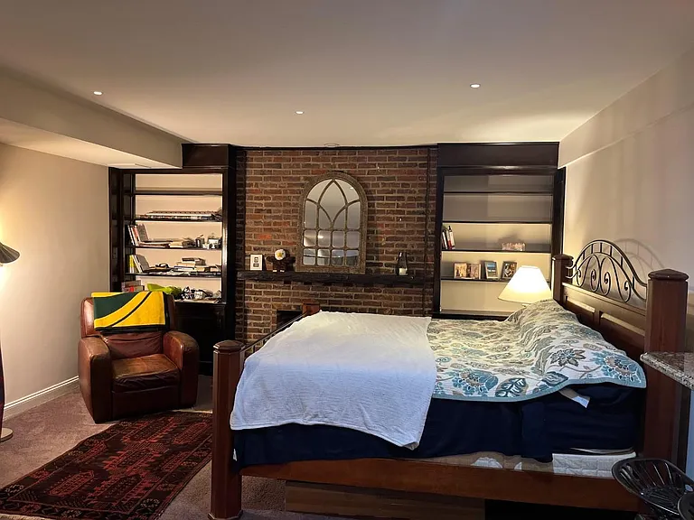 Fireplace is flanked by built-ins.