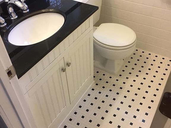 Beautiful Black and White Bath with plenty of storage