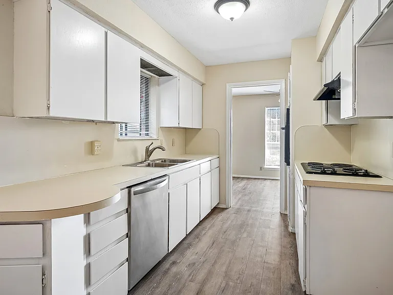 Kitchen with lots of cabinets & countertop space with a stainless dishwasher, electric cooktop & built in oven. It is open to the breakfast area.