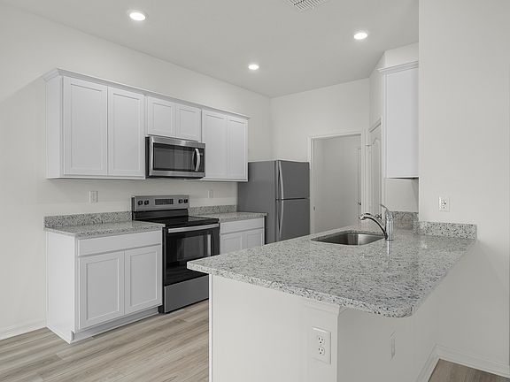 Chef-ready kitchen with granite countertops and white cabinets
