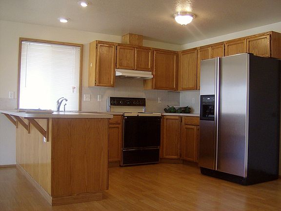 recessed lighting, breakfast bar, stainless steel refrigerator