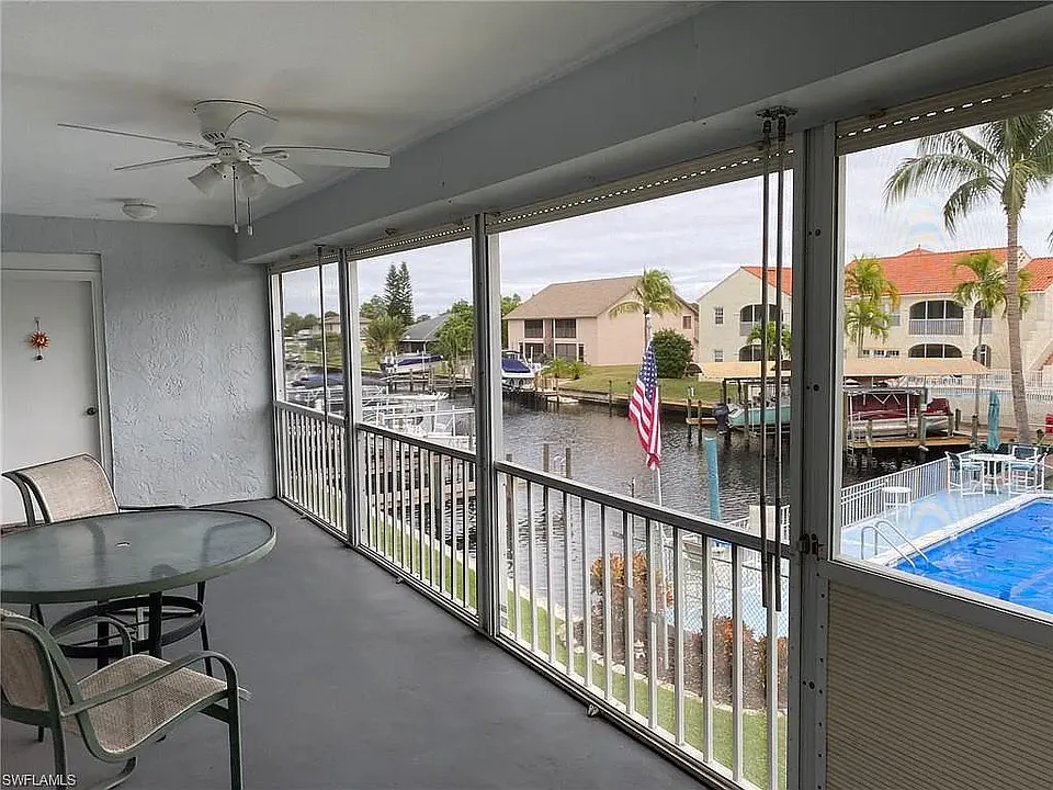 Back Lanai that extends across living room and primary bedroom with fabulous view over pool. Comes complete with your own shared circular staircase going directly down to pool for convenience.