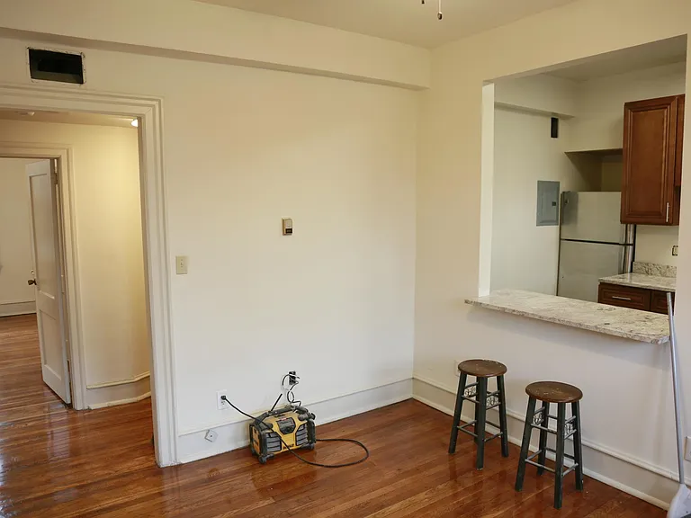different angle of the living room looking into the hallway to the bedroom area, and to the bathroom.