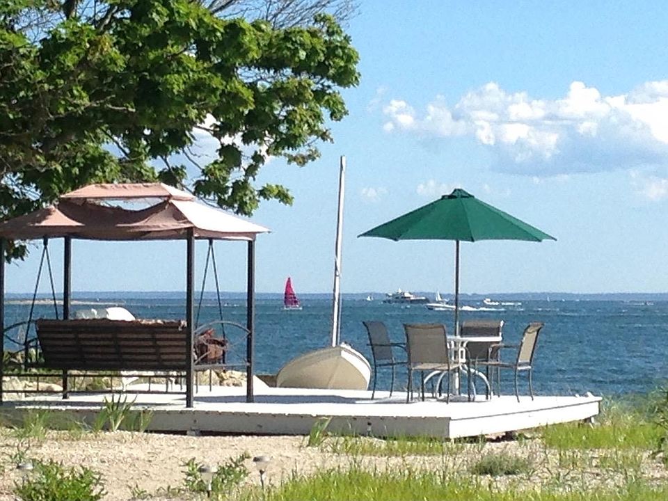 Your own private beach and beach deck is just across from an outside deck off the house and a spacious green lawn