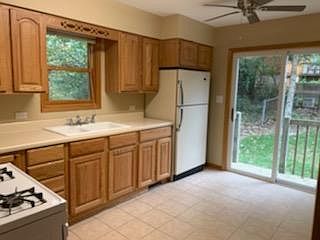 Kitchen with sliding glass door to back yard.
