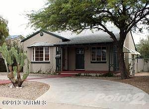 Old mesquite tree shades the front