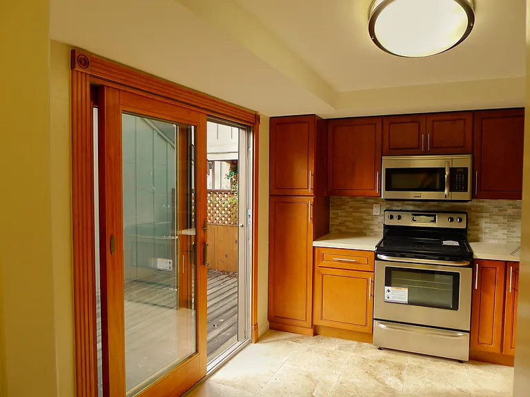 kitchen with doors to small deck, & to garage.
