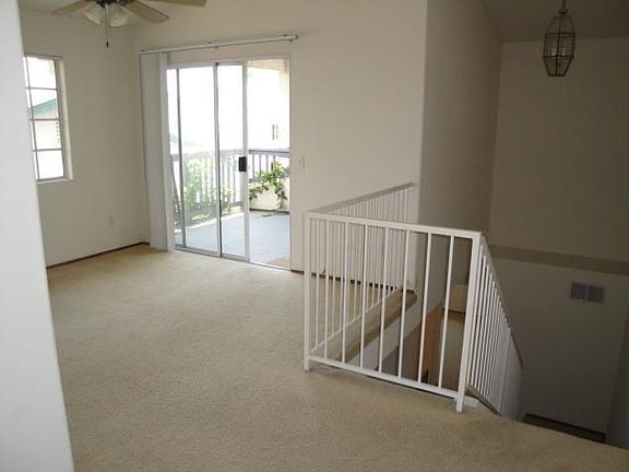 Upstairs Bedroom/Loft with Balcony. Flooring has been upgraded to grey Laminate flooring.