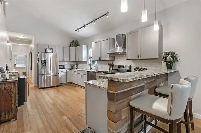 As you step further in, you can see the spacious kitchen area with plenty of counter space.