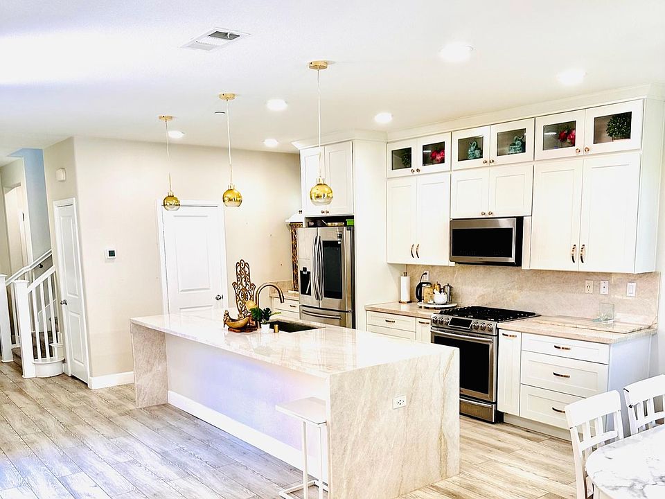 Kitchen: Upgraded appliances, natural quartzite stone waterfall island and countertops