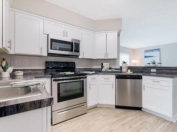 Kitchens feature stainless steel appliances.