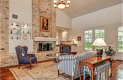Stunning living room with high ceilings, fireplace and custom Fr