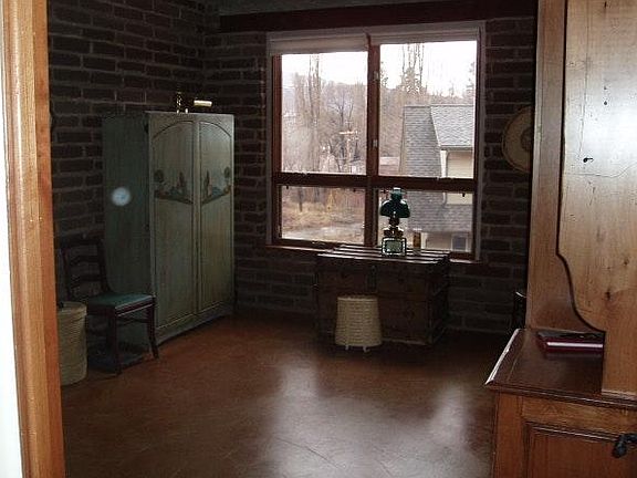 guest bedroom with separate corridor entry adjacent to entry from garage, with built-in QS murphy bed and cabinetry