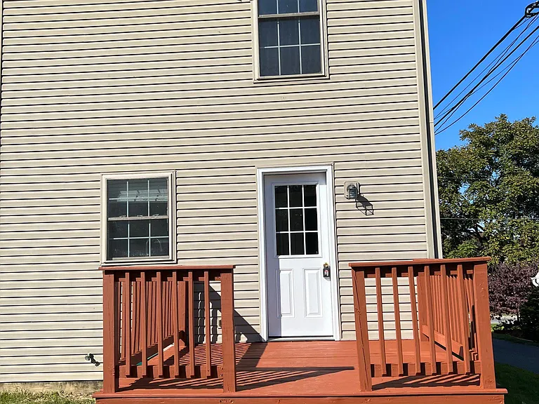 Back view of house and freshly painted deck.