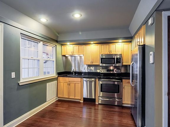 kitchen from eating area, windows and door to private pation on left