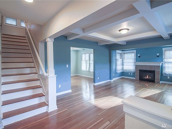 Looking from the entrance. Gorgeous original Fir floors, Craftsman ceiling work, gas FP. Opening in center leads to the dining room.
