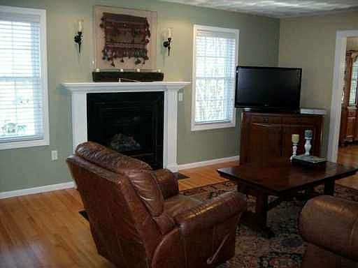 Lovely gas fireplace in spacious living room. Stunning color palette. 