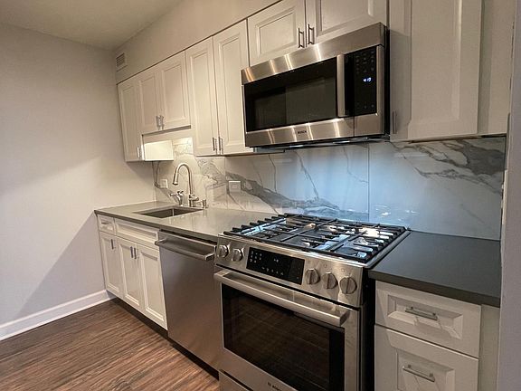 All new kitchen with instant hot water dispenser, quiet dishwasher, and 5-burner gas stove with oven and warming drawer.