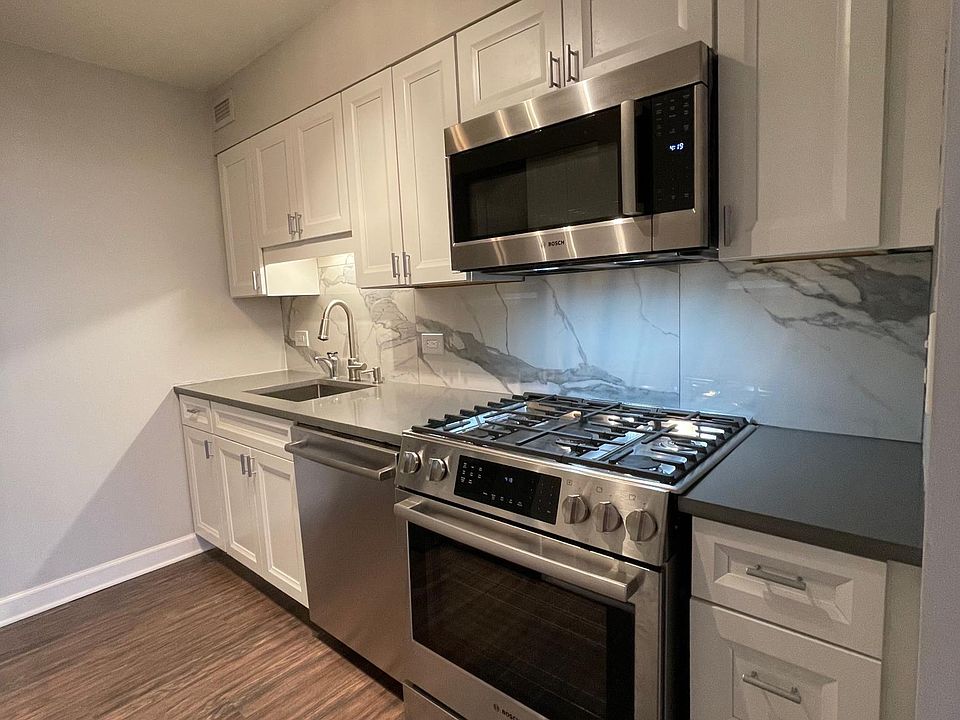 All new kitchen with instant hot water dispenser, quiet dishwasher, and 5-burner gas stove with oven and warming drawer.