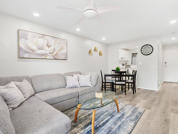 Additional view of Living Room, with entry to Kitchen, entry door and hallway to the right for bedrooms/bath.