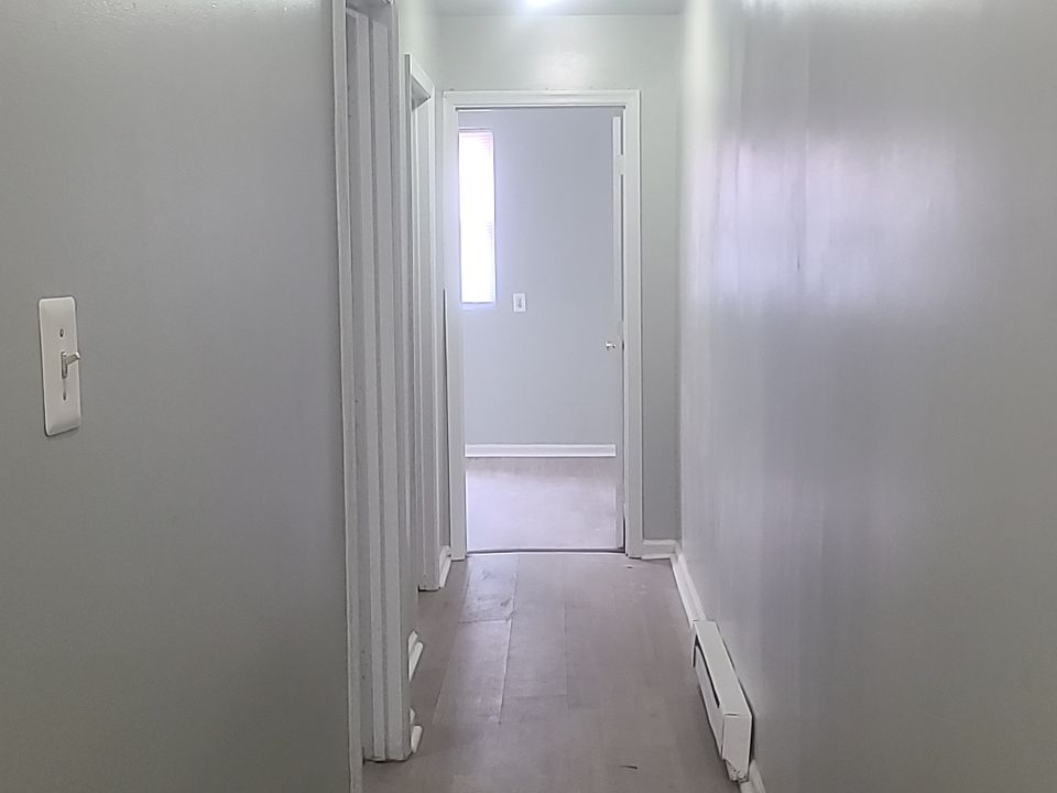 Long hallway leading to both bedrooms